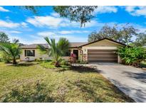 Beautiful ranch home with a large yard, driveway, and mature trees at 3112 Needle Palm Dr, Edgewater, FL 32141