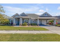 Single-story home with gray siding, a three-car garage, and a landscaped yard at 3203 Monaco Blvd, New Smyrna Beach, FL 32168