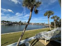 Stunning waterfront view with palm trees and boats at 335 N Causeway # H23, New Smyrna Beach, FL 32169