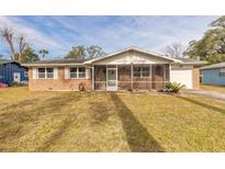 Brick ranch home with screened porch and spacious yard at 413 Division Ave, Ormond Beach, FL 32174