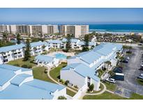 Aerial view of condo community near beach with pool and parking at 4590 S Atlantic Ave # 258A, Ponce Inlet, FL 32127