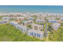 Stunning aerial view of beachfront condos, lush greenery, and ocean views at 5300 S Atlantic Ave # 5-206, New Smyrna Beach, FL 32169