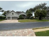 Beautiful two-story home with a three-car garage and manicured lawn at 720 Stonewood Ct, New Smyrna Beach, FL 32168