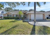 Brick house with a well-maintained lawn and palm trees at 809 E 7Th Ave, New Smyrna Beach, FL 32169