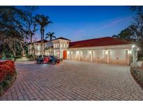 Elegant two-story home with a three-car garage and a brick driveway at 817 Hail Ct, Port Orange, FL 32127