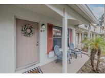 Inviting front porch with seating and charming decor at 980 Canal View Blvd # C7, Port Orange, FL 32129