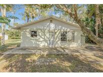 Ranch style home with a white exterior and mature landscaping at 2515 Fairfax Ave, New Smyrna Beach, FL 32168