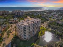 Beautiful aerial view of the condo building overlooking the ocean and beach at 265 Minorca Beach Way # 204, New Smyrna Beach, FL 32169