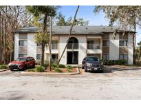 Exterior of a multi-Gathering home with manicured landscaping and two cars parked out front at 2910 Oak Trail Run # 10, Port Orange, FL 32127