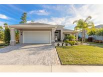 Single-story home with a two-car garage and landscaped front yard at 3012 Portofino Blvd, New Smyrna Beach, FL 32168