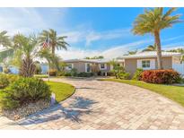 Single-story home with circular driveway, palm trees, and manicured landscaping at 3862 Cardinal Blvd, Port Orange, FL 32127