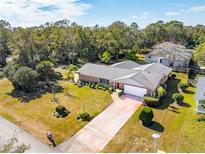 Aerial view of single-story home with large yard and driveway at 51 Club House Blvd, New Smyrna Beach, FL 32168