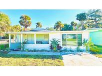 Charming Florida bungalow with a spacious front porch and well-manicured landscaping at 69 E Bayshore Dr, Port Orange, FL 32127