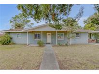 Ranch-style home with carport and mature landscaping at 904 Wilkins St, New Smyrna Beach, FL 32168