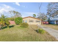 Charming single-story home featuring a well-maintained yard and classic curb appeal at 2323 Queen Palm Dr, Edgewater, FL 32141