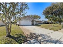 Charming brick home featuring a well-maintained lawn and a spacious two-car garage at 234 Meadow Lake Dr, Edgewater, FL 32141