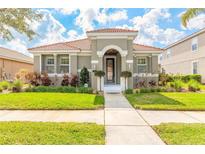 Charming home featuring a tiled roof, manicured lawn, and inviting front entrance at 3456 Pegaso Ave, New Smyrna Beach, FL 32168