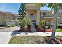 Inviting two-story home with a well-manicured lawn and a charming brick driveway at 3546 Casalta Cir, New Smyrna Beach, FL 32168