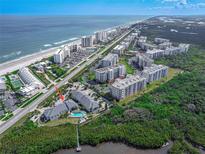 An aerial view of the condo community, beachfront, and amenities, showcasing its desirable coastal location at 4860 S Atlantic Ave # 1030, New Smyrna Beach, FL 32169