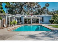 Refreshing pool with brick trim offers an inviting backyard oasis for relaxation and entertainment at 820 Faulkner St, New Smyrna Beach, FL 32168