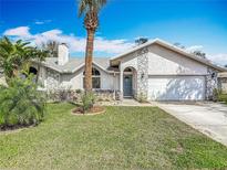 Charming single-story home showcasing well-maintained landscaping and a beautiful, textured facade at 1175 Margina Ave, Daytona Beach, FL 32114