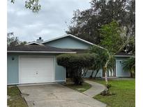 Charming one-story home with a well-manicured lawn, two-car garage and mature landscaping at 1774 Concert Rd, Deltona, FL 32738