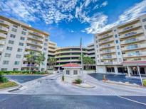 Inviting condo complex with well-maintained landscaping, covered parking, and a charming guard house at 3 Oceans West Boulevard # 3B1, Daytona Beach Shores, FL 32118