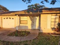 Home exterior featuring a one car garage and covered entry at 309 Sea Hawk Ct, Edgewater, FL 32141