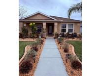 Charming single-story home with a meticulously landscaped front yard and walkway at 3368 Tuscano Ne Ave, New Smyrna Beach, FL 32168