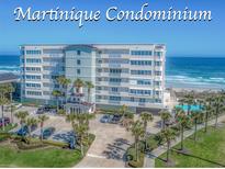 Beautiful condominium with a coastal design, lush landscaping, ocean views, and a large pool at 4767 S Atlantic Ave # 404, Ponce Inlet, FL 32127