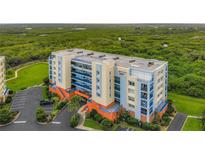 Beautiful condominium building with manicured landscaping and ample parking at 5300 S Atlantic Ave # 5-407, New Smyrna Beach, FL 32169