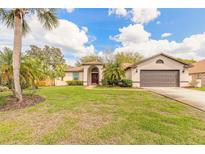 Charming single-story home featuring a lush green lawn, palm trees, and a well-maintained exterior at 15 Katrinas Dr, Ormond Beach, FL 32174
