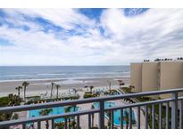 Beautiful oceanfront view from a balcony overlooking the pool and beach at 2401 S Atlantic Ave # A604, New Smyrna Beach, FL 32169