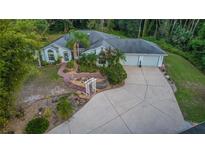 Stunning single Gathering home with lush landscaping, a paved driveway, and attached two-car garage at 2576 Shilo Glynn Ln, New Smyrna Beach, FL 32168