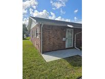 Exterior view of the brick house showcasing its charming curb appeal and well-maintained lawn on a sunny day at 36 Fairway Ct # 36, Deland, FL 32724