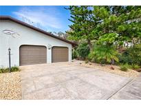 Spacious two-car garage with neutral doors and beautiful landscaping. A marlin adds a nautical touch to this coastal retreat at 4035 Saxon Dr # A3, New Smyrna Beach, FL 32169