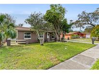Charming single-story home with a well-maintained lawn and lush landscaping at 612 Cedar Park Dr, Daytona Beach, FL 32114