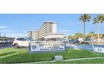 Captain's Quarters condominium complex signage at 101 North Riverside Drive with palm trees in the background at 101 N Riverside Dr # 214, New Smyrna Beach, FL 32169
