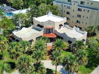 Beautiful Mediterranean-style home featuring mature palm trees, a red tile roof, and a spacious layout at 746 N Halifax Ave, Daytona Beach, FL 32118