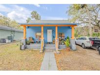 Charming blue home with orange trim, featuring a cozy front porch and a well-maintained walkway at 812 Marion St, Daytona Beach, FL 32114