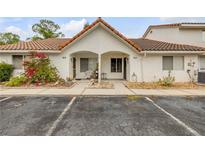 Charming condo with a terracotta roof, front patio, and freshly manicured landscaping at 3522 Forest Branch Dr # B, Port Orange, FL 32129