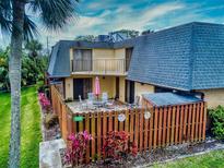 Charming condo featuring a private patio and vibrant landscaping for outdoor enjoyment at 133 Cedar Dunes Dr, New Smyrna Beach, FL 32169