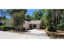 Inviting single-story home with a well-maintained lawn and mature trees, presenting an appealing curb appeal at 171 Fox Glen Ct, Ormond Beach, FL 32174