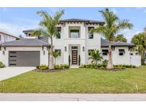 Stunning two-story home with a modern design, lush landscaping, and inviting curb appeal at 212 Due East St, New Smyrna Beach, FL 32169