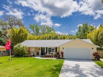 Charming single-story home with a well-manicured lawn and a two-car garage at 2236 Davis Dr, New Smyrna Beach, FL 32168