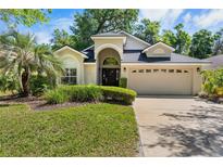 Charming single-story home featuring a well-maintained lawn, mature landscaping and a two-car garage at 3349 Glenshane Way, Ormond Beach, FL 32174
