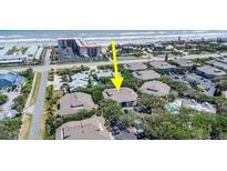 An aerial view of a charming condo complex near the ocean, showcasing nearby beach access and lush landscaping at 4307 Sea Mist Dr # 135, New Smyrna Beach, FL 32169