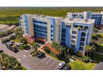 Beautiful exterior view of the condo complex, showcasing manicured landscaping and ample parking at 5300 S Atlantic Ave # 14-202, New Smyrna Beach, FL 32169