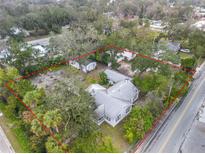 Expansive property with charming home, garage, and storage building all within a tree-lined and private lot at 801 Canal St, New Smyrna Beach, FL 32168