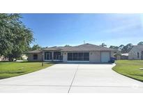 Single-story home featuring a spacious driveway and well-maintained landscaping at 2530 Tamarind Dr, Edgewater, FL 32141